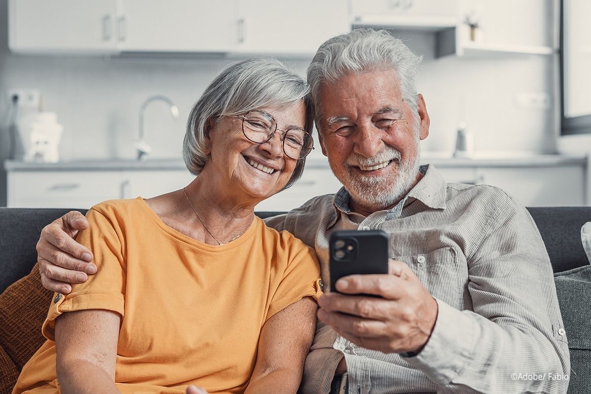 Ein älteres Paar schaut gemeinsam in ein Handy
