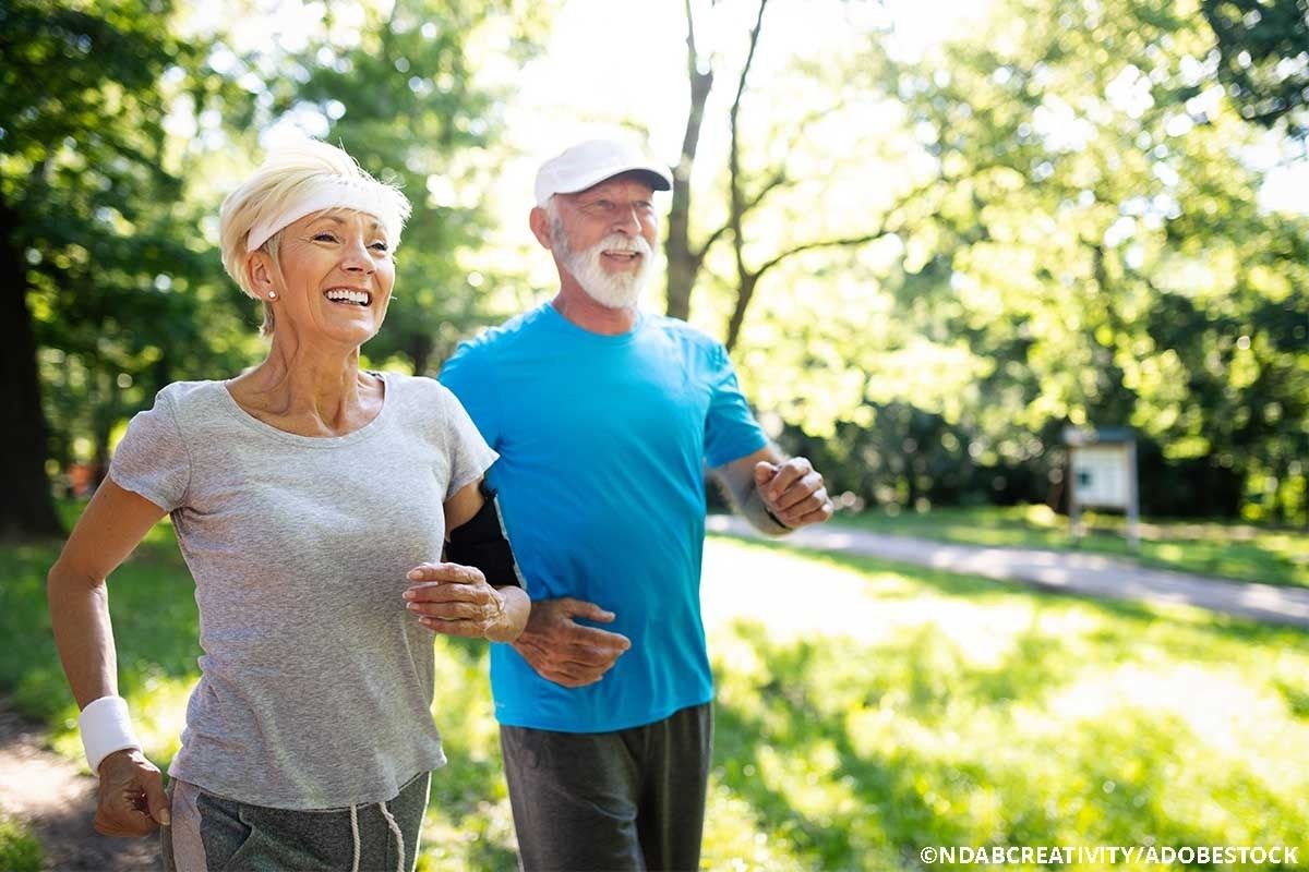 Älteres Pärchen gehen in Park gemeinsam joggen.